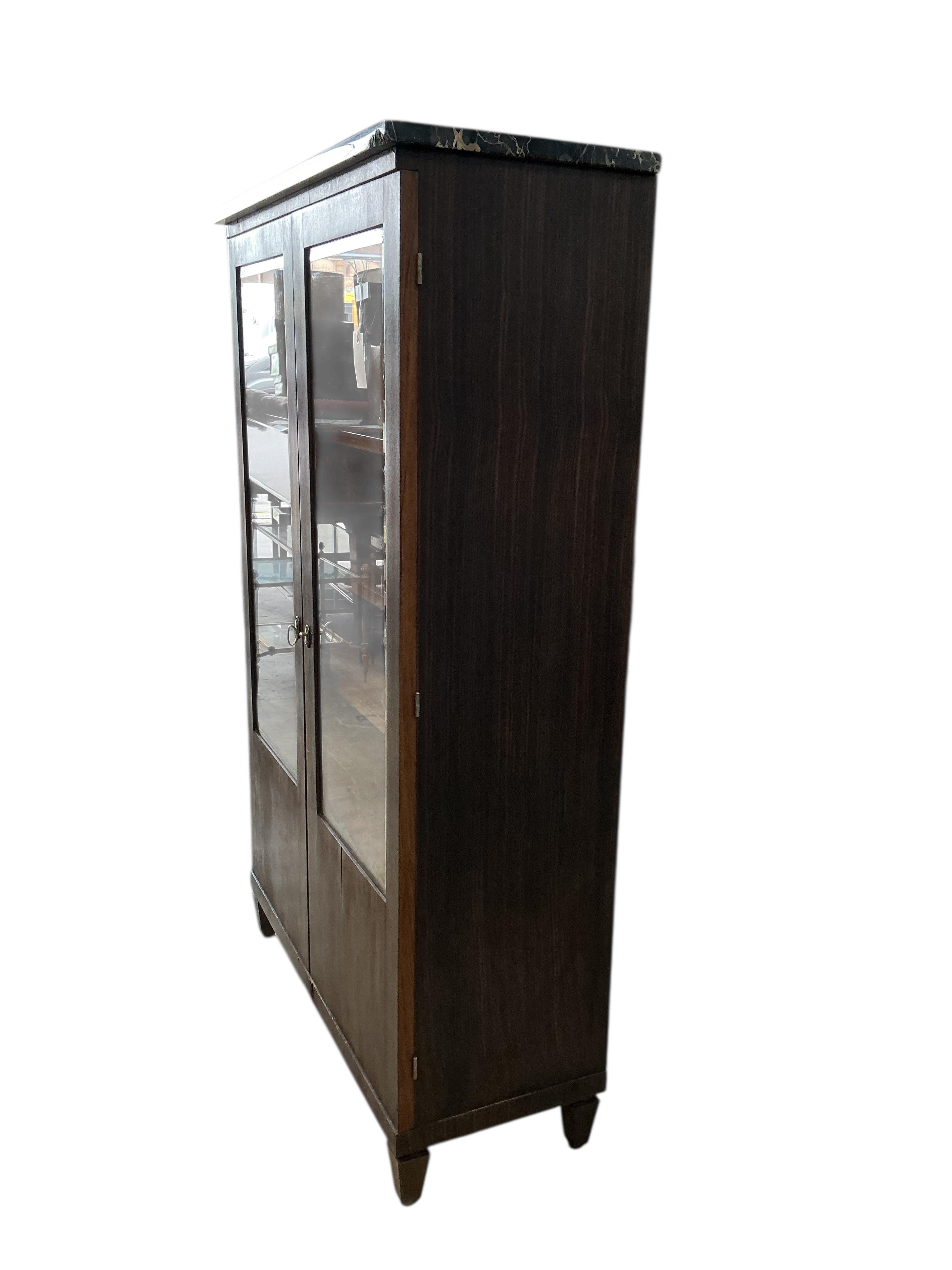 A French Art Deco marble topped coromandel bookcase, width 92cm, depth 38cm, height 151cm